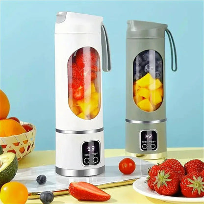 blender smoothie banc et vert  contenant des morceaux de mangue sur la table, entourés de fraises, d'oranges, et d'avocat