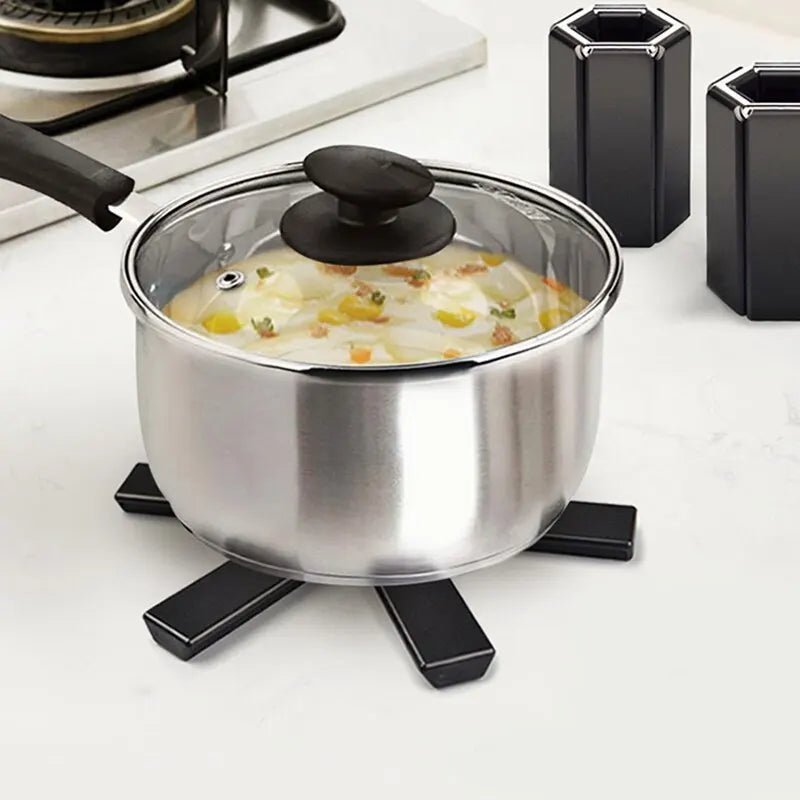 Casserole en inox avec couvercle transparent, bouillon et légumes, posée sur un chou futé hexagonal pliable DESSOUS DE PLAT PLIABLE - HEXAGONE™.