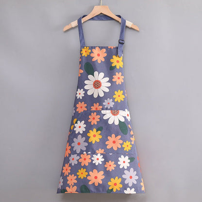 Tablier de cuisine fleuri bleu à motifs daisies multicolores, avec cordons réglables et poches.